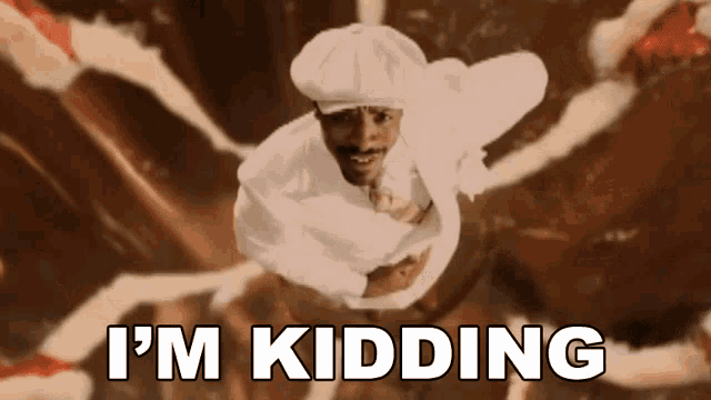 a man in a chef 's hat is flying through the air with the words i 'm kidding above him
