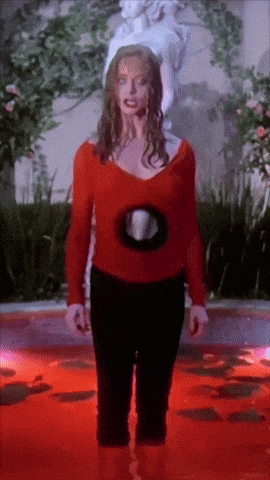 a woman in a red sweater is standing in a pool of blood