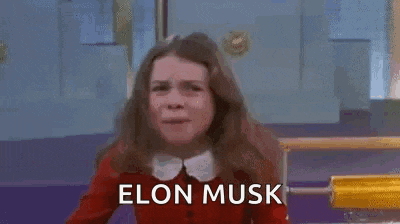 a girl in a red sweater is making a funny face while holding her hair in the air .
