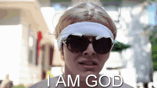 a woman wearing sunglasses and a headband with the words i am god on it