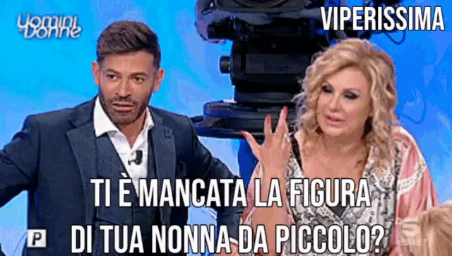 a man and a woman are sitting in front of a camera with viperissima written on the screen