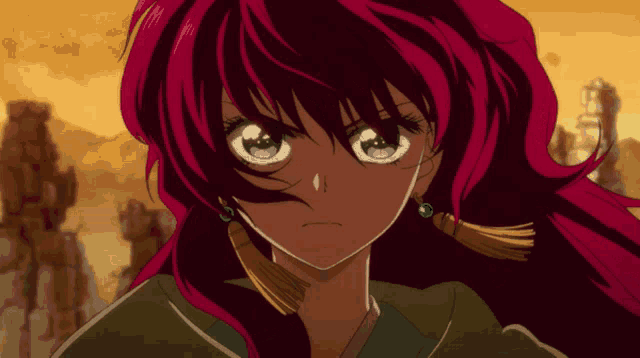 a girl with red hair and blue eyes is wearing earrings