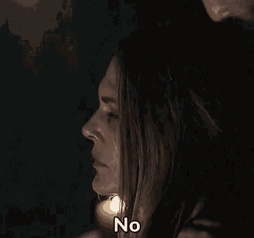 a close up of a woman 's face with the word no on her face .