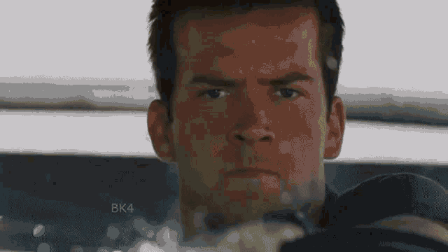 a close up of a man 's face with the word bk4 on the bottom right corner .