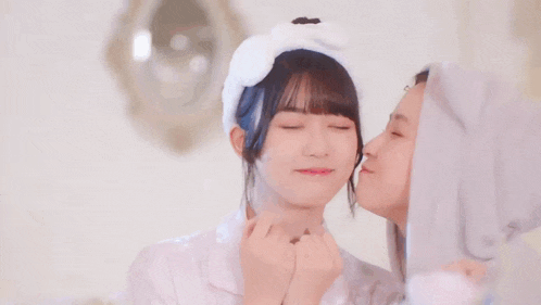 a couple of girls are standing next to each other and one of them is wearing a cat costume .