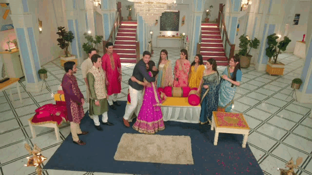 a group of people are standing around a bride and groom