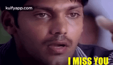 a close up of a man 's face with the words `` i miss you '' written on it