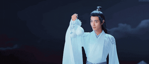 a man in a white robe is holding a white object
