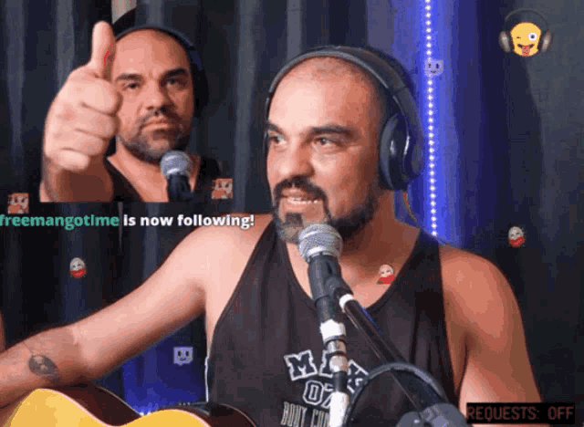 a man giving a thumbs up in front of a microphone with the words freemangotime is now following