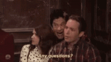 a group of people are sitting next to each other and one of them is saying `` any questions ? '' .