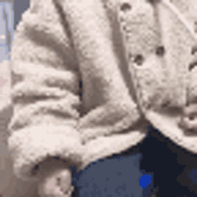 a close up of a person wearing a fur coat