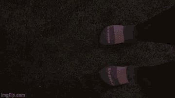 a person wearing bombas socks standing on a carpet