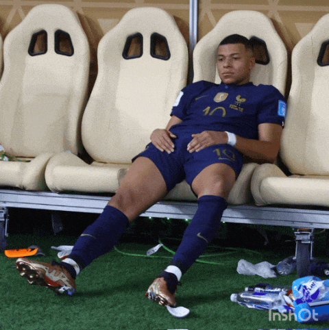 a soccer player laying on a bench with the number 10 on his shirt