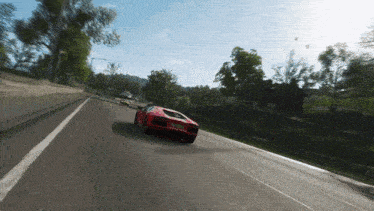 a red sports car is driving down a road with a license plate that says ' nz '