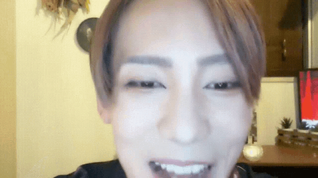 a close up of a person 's face with a computer screen in the background