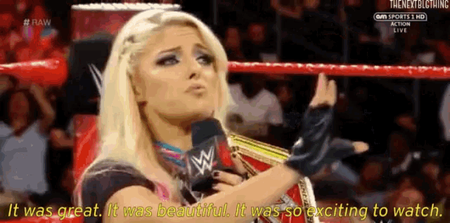 a woman is talking into a microphone in a wrestling ring and says it was great it was beautiful it was so exciting to watch