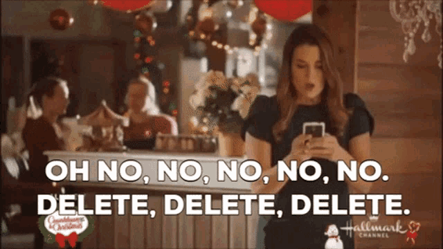 a woman is looking at her phone and says " oh no no no no delete delete delete "