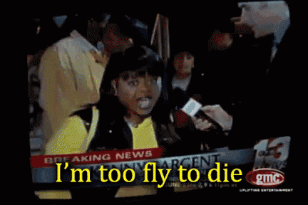 a girl is being interviewed on a news channel and the words i 'm too fly to die are on the screen