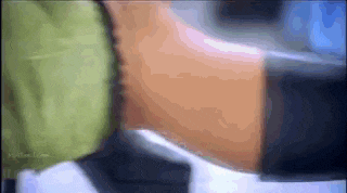 a close up of a person 's torso with a green shirt on .