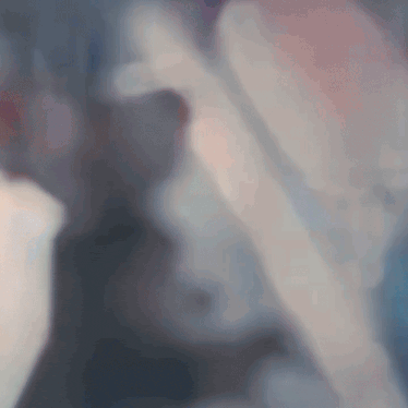 a blurry picture of a person 's face with a blue and pink background