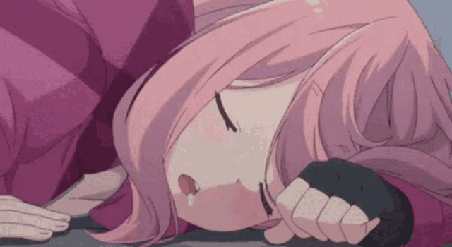a girl with pink hair is sleeping on the floor with her eyes closed and her mouth open .