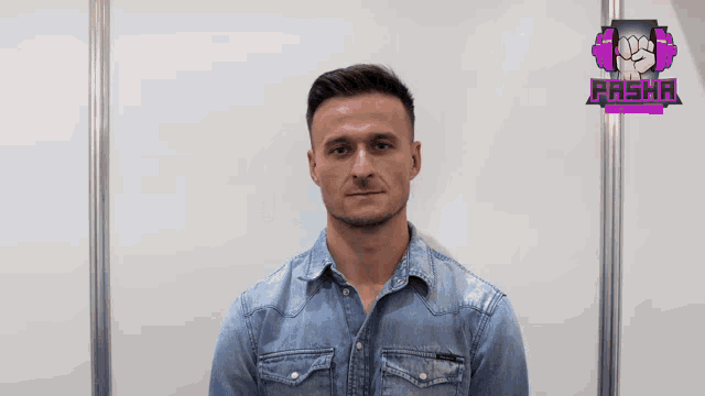 a man in a denim shirt stands in front of a sign that says pasha on it