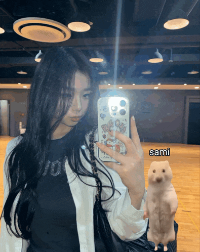 a girl taking a picture of herself in a mirror with sami written on the bottom