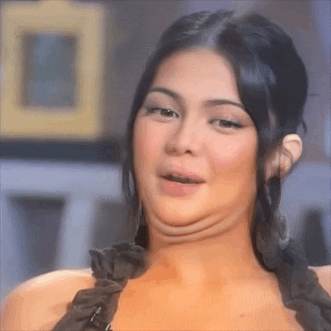 a woman with a double chin is making a funny face while talking to someone .