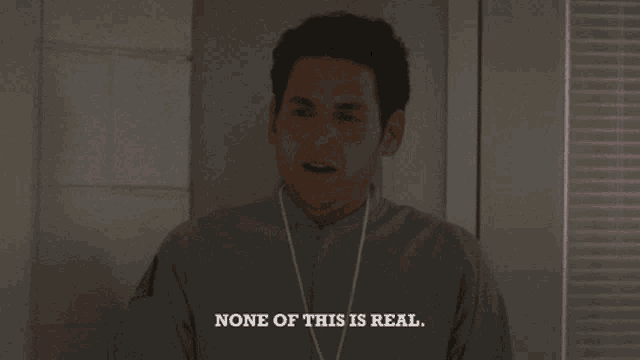 a man says " none of this is real " in a dark room
