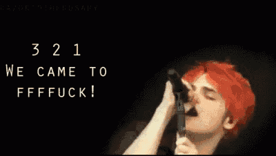 a man with red hair is singing into a microphone with the words we came to ffffuck written above him .