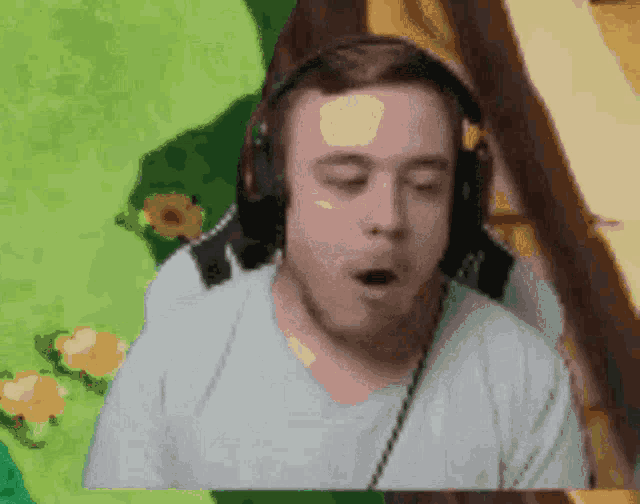 a man wearing headphones is making a funny face with his mouth open .