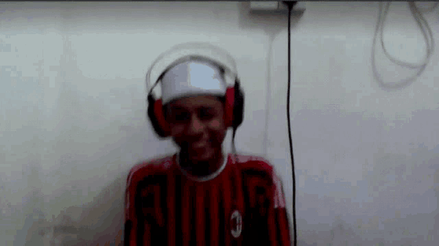 a man wearing headphones and a red shirt with the number 3 on the front
