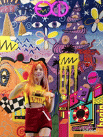 a woman with red hair is standing in front of a colorful painting with a yellow sign that says m on it