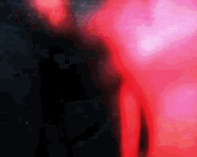 a red and black background with a blurred image