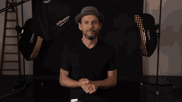 a man wearing a hat says danke in front of some lights