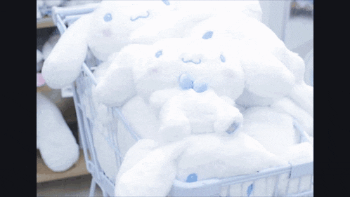 a bunch of stuffed animals in a basket including a cinnamoroll