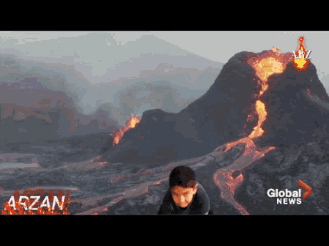 a boy is sitting in front of a volcano with the words global news written on the bottom