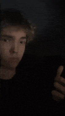 a young man wearing headphones makes a funny face