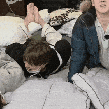 a group of people laying on a bed with khjactivity written in the corner