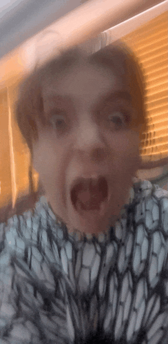 a close up of a person 's face with their mouth open