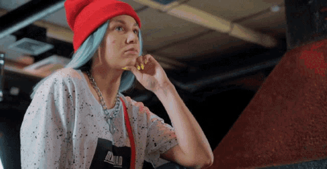 a woman wearing a red hat and a t-shirt that says squad on it