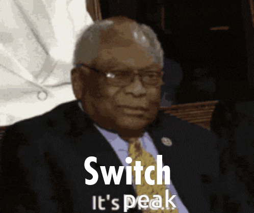 a man in a suit and tie with the words switch it 's peak