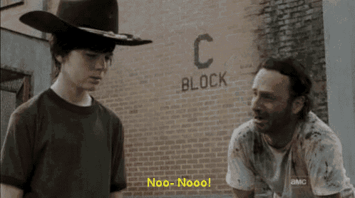two men are standing in front of a brick wall that says c block on it