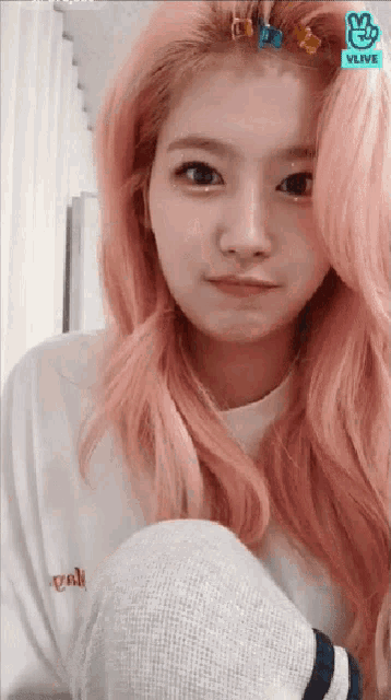 a girl with pink hair is wearing a white shirt that says " pink "