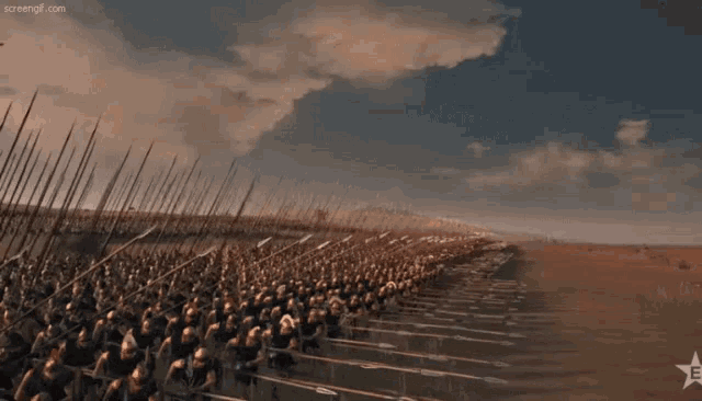 a large group of soldiers are lined up in a field with a star in the corner that says screenshot.com