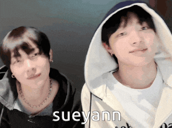 two young men are standing next to each other and the name sueyann is on the bottom