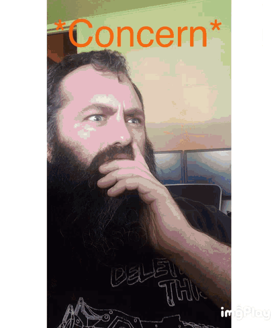 a man with a beard wears a shirt that says delete this on it