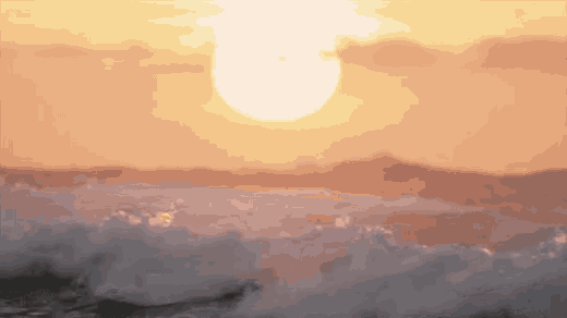 a sunset over the ocean with waves crashing on the shore