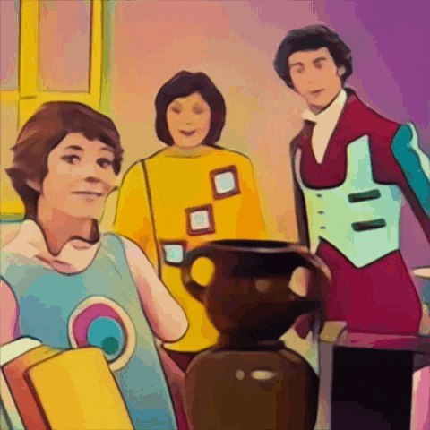 a group of people standing around a brown vase