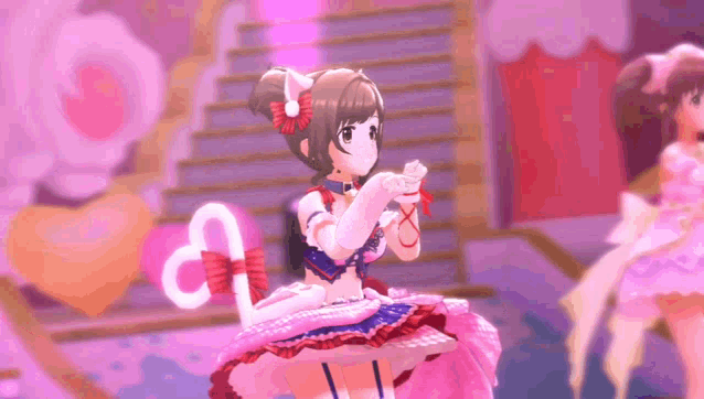 a girl in a pink dress with a cat ear is dancing on a stage .